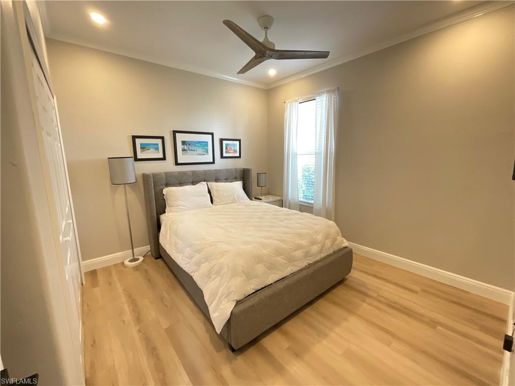 1709 Marsh Run Naples, FL 34109 - Photo 14 of 19 a bedroom with a bed and a painting on the wall