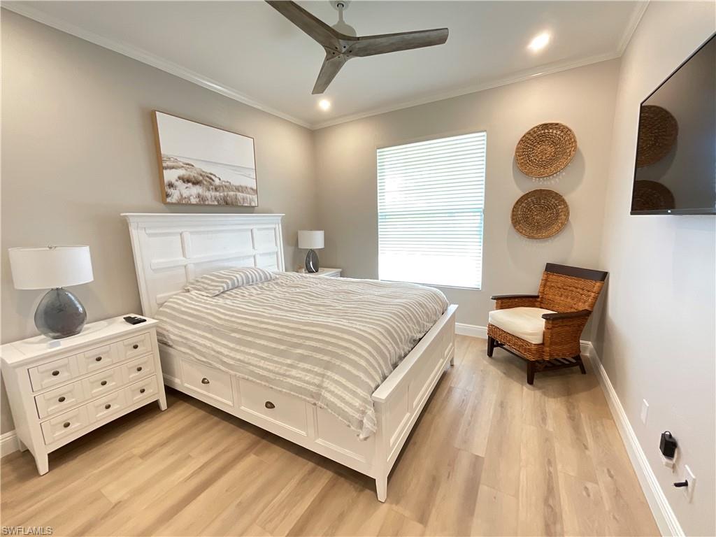 1709 Marsh Run Naples, FL 34109 - Photo 15 of 19 a bedroom with a bed and a lamp