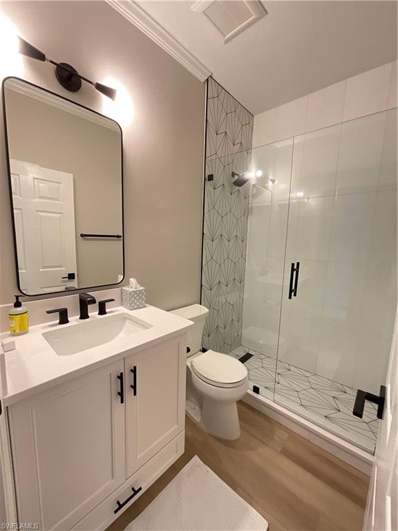 1709 Marsh Run Naples, FL 34109 - Photo 16 of 19 a bathroom with a sink toilet a mirror and shower