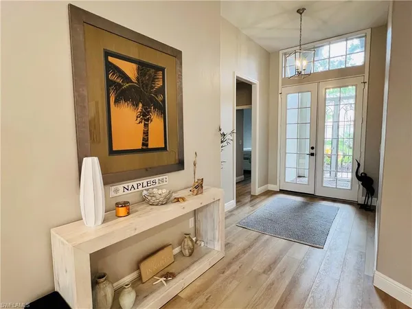 a bathroom with a sink a mirror and next to a window