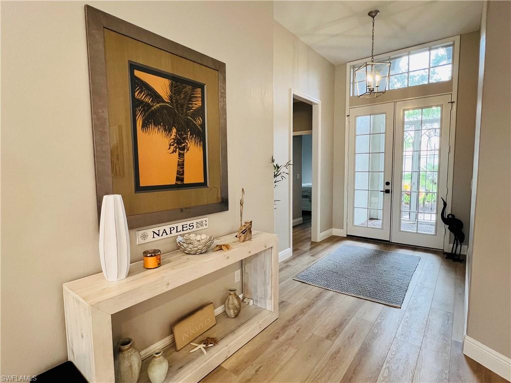 1709 Marsh Run Naples, FL 34109 - Photo 6 of 19 a bathroom with a sink a mirror and next to a window