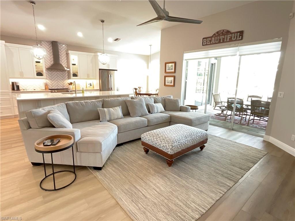1709 Marsh Run Naples, FL 34109 - Photo 10 of 19 a living room with furniture and a table