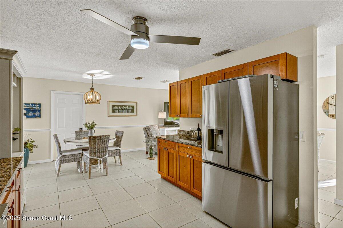 2007 Oak Street Melbourne Beach, FL 32951 - Photo 26 of 53 a kitchen with stainless steel appliances granite countertop a refrigerator and a stove top oven