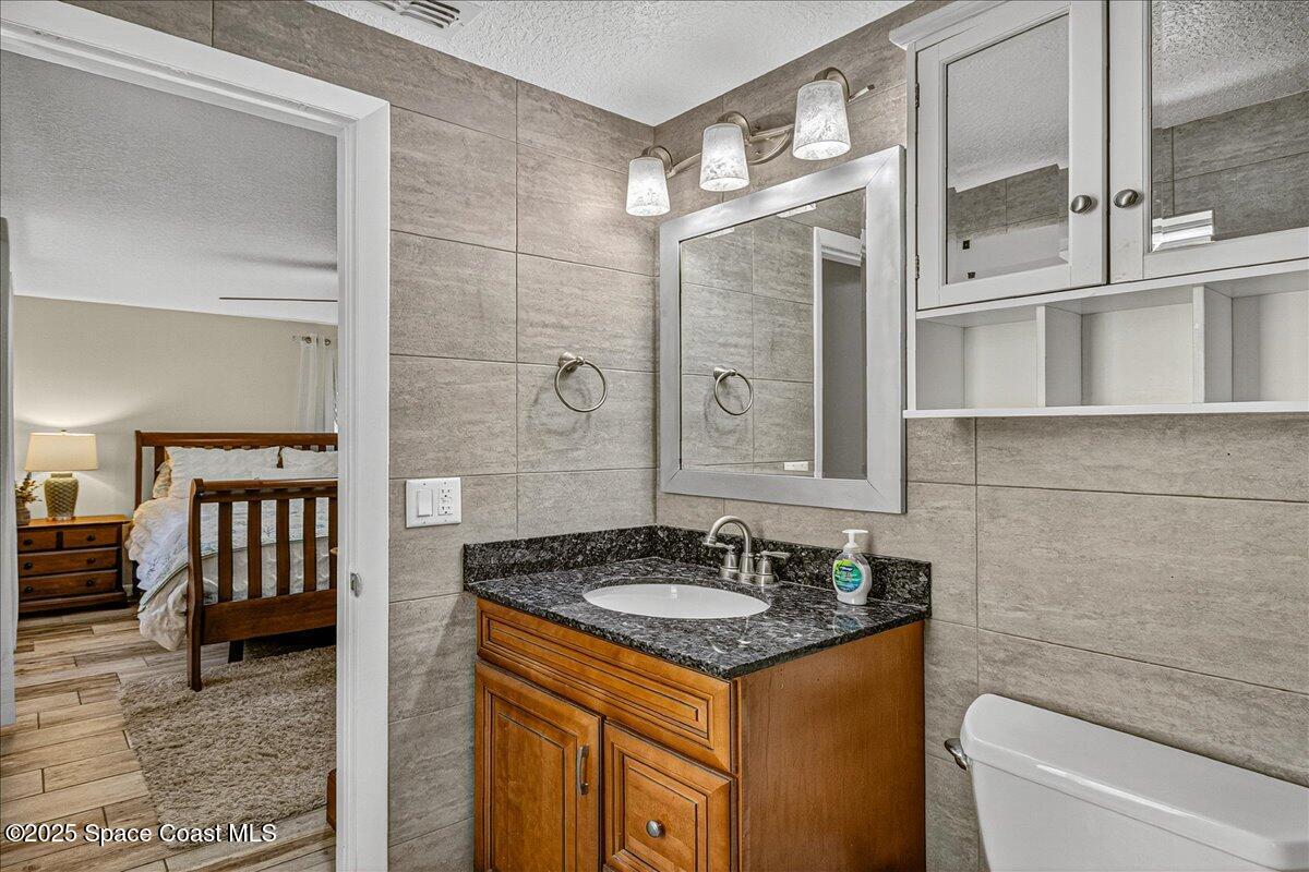 2007 Oak Street Melbourne Beach, FL 32951 - Photo 34 of 53 a bathroom with a sink and a mirror