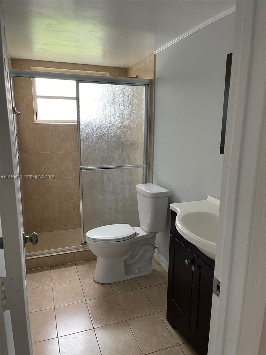 7670 Southwest 82nd Street, Unit H113 Miami, FL 33143 - Photo 13 of 14 a bathroom with a toilet and a shower