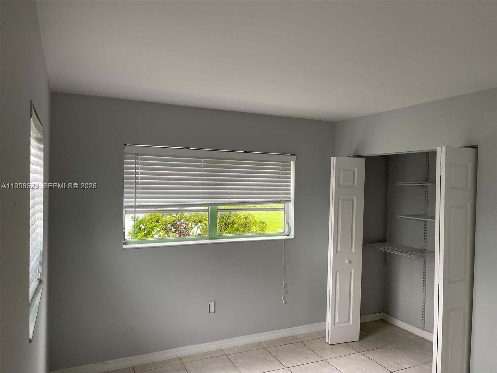 7670 Southwest 82nd Street, Unit H113 Miami, FL 33143 - Photo 6 of 14 a view of an empty room with a window