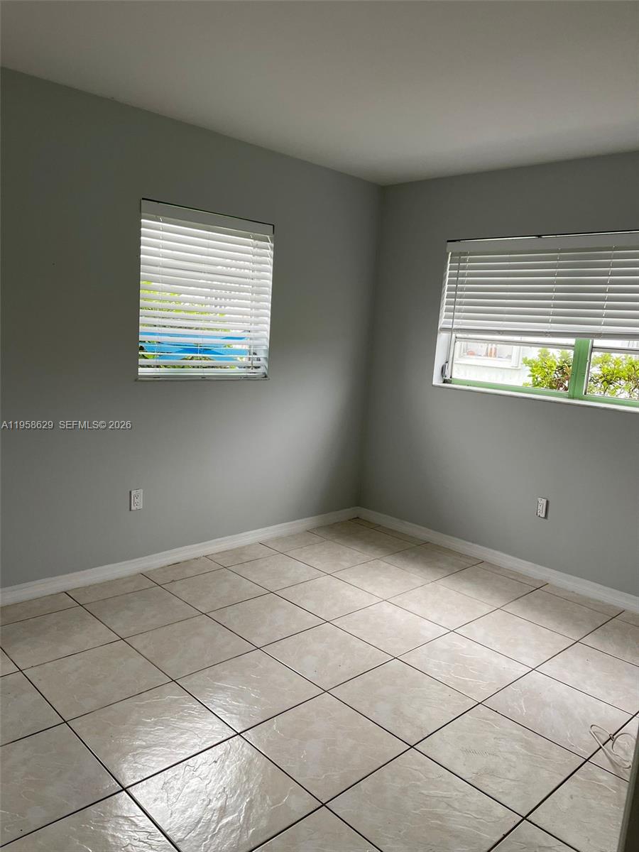 7670 Southwest 82nd Street, Unit H113 Miami, FL 33143 - Photo 7 of 14 a view of an empty room with a window