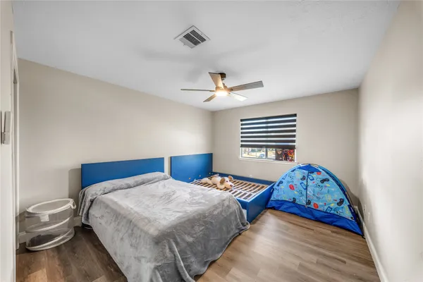 a bedroom with a bed and a window