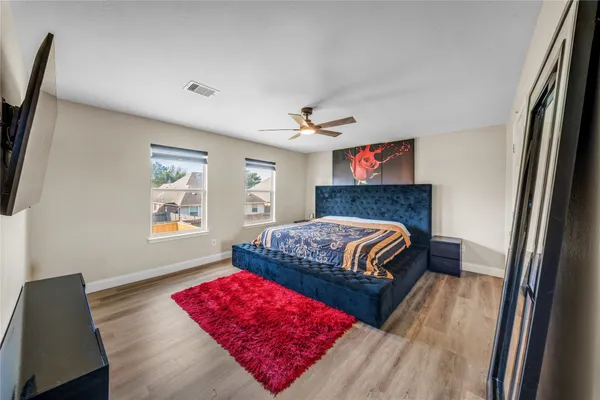 a bedroom with a bed and a couch