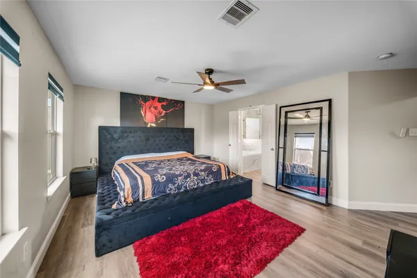 a bedroom with a bed and a couch