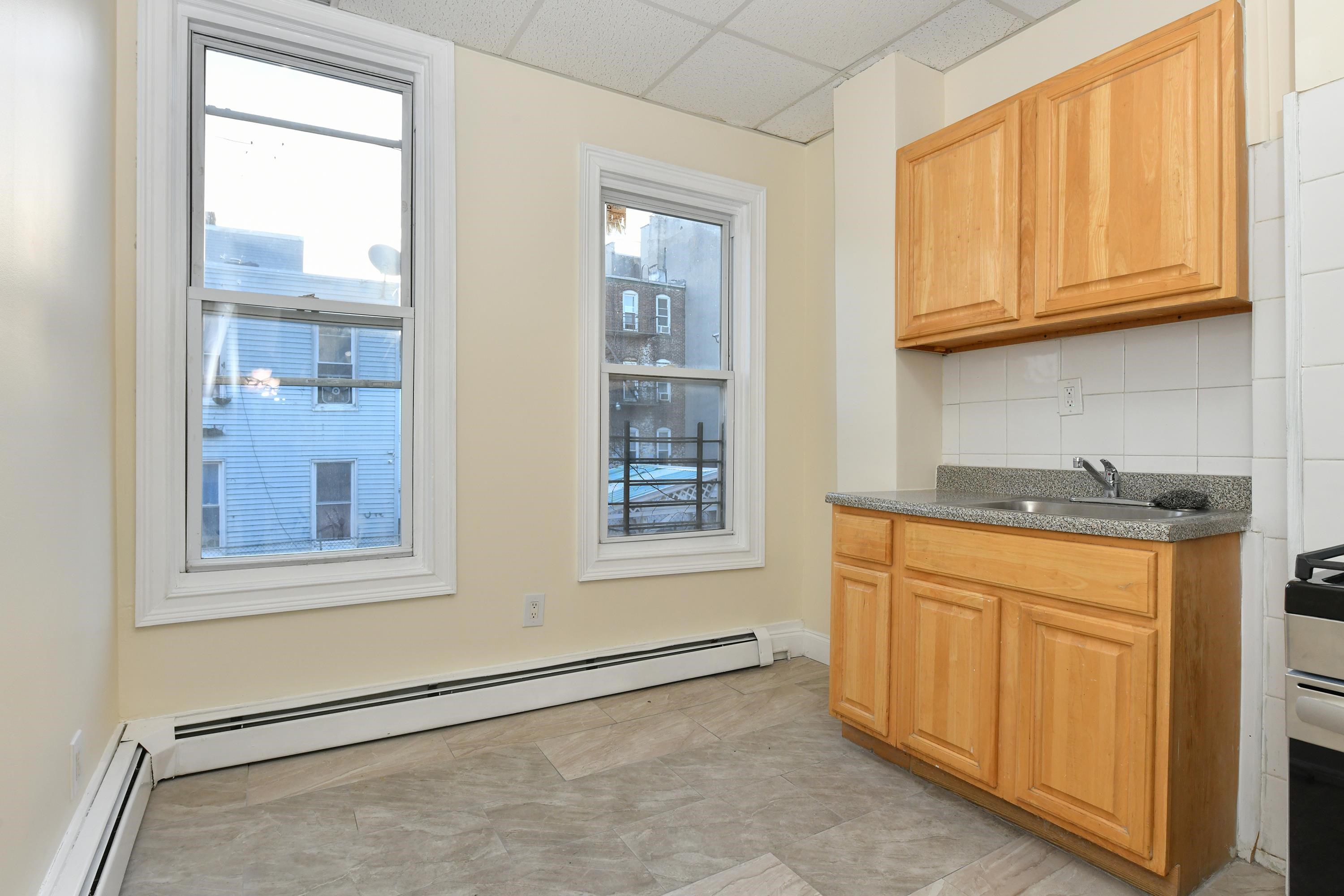 531 28th Street, Unit 1 Union City, NJ 07087 - Photo 15 of 21 a view of a kitchen with stainless steel appliances granite countertop cabinets and a window
