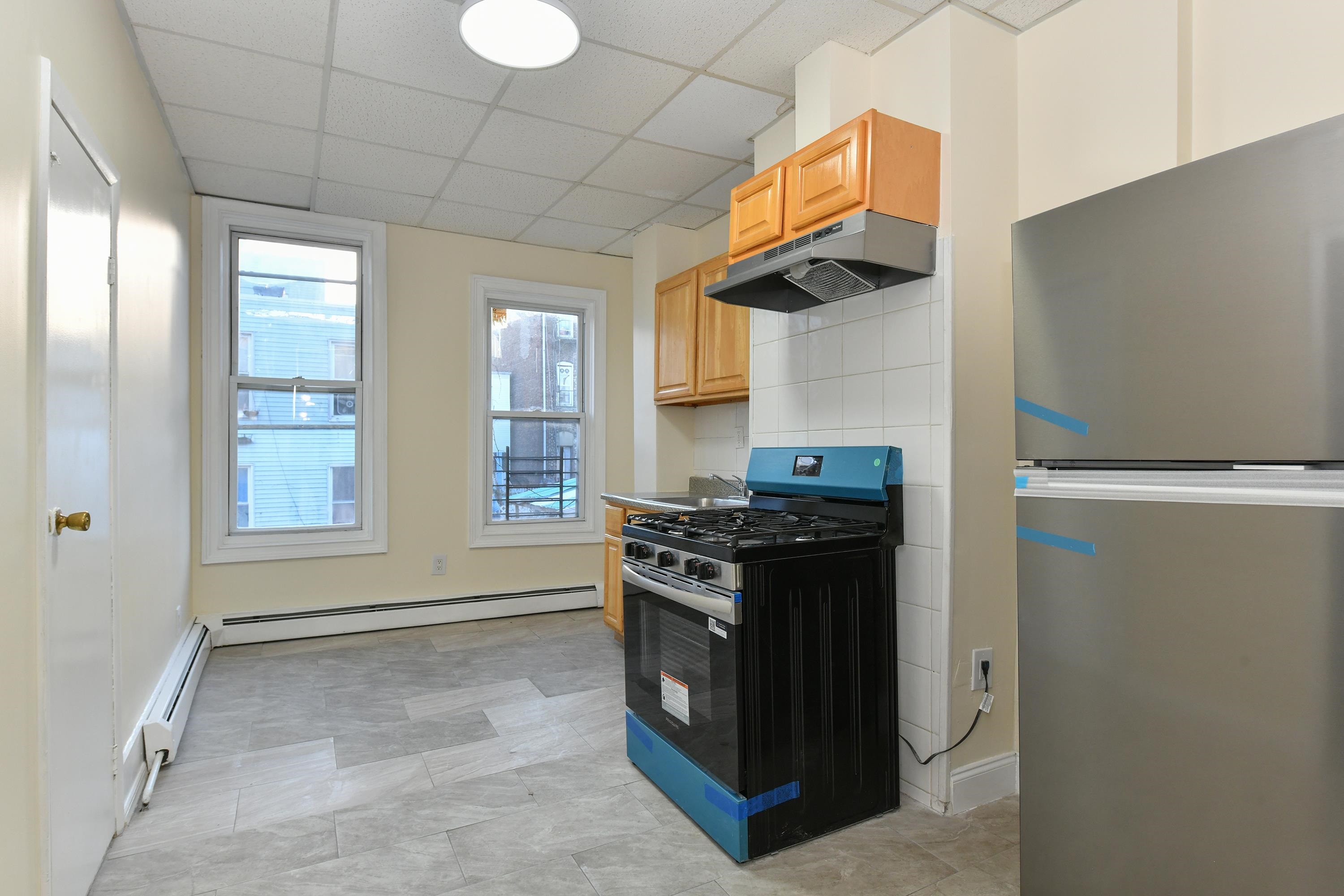 531 28th Street, Unit 1 Union City, NJ 07087 - Photo 3 of 21 a kitchen with granite countertop a stove and a sink