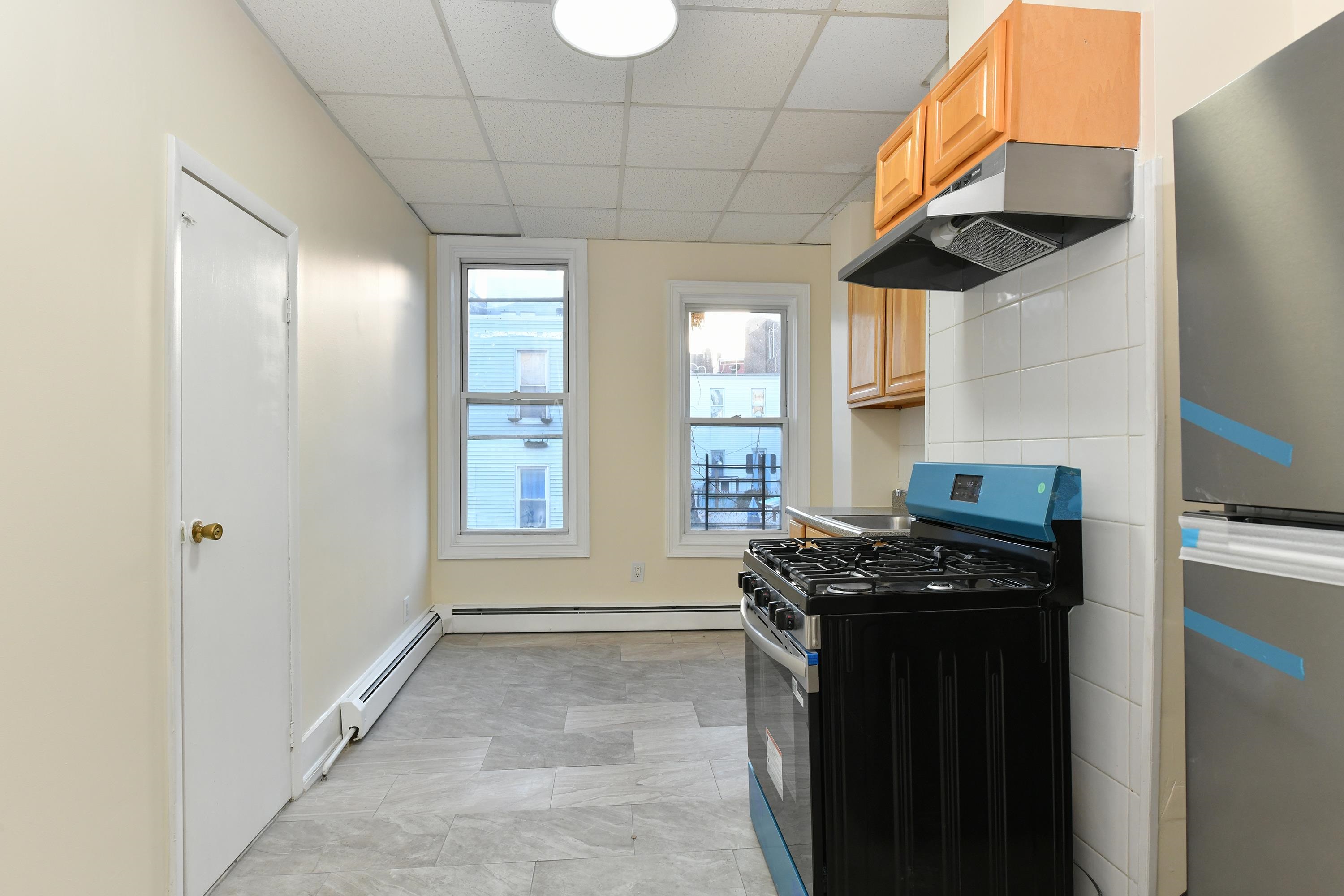531 28th Street, Unit 1 Union City, NJ 07087 - Photo 4 of 21 a kitchen with stainless steel appliances granite countertop a stove a sink and a refrigerator