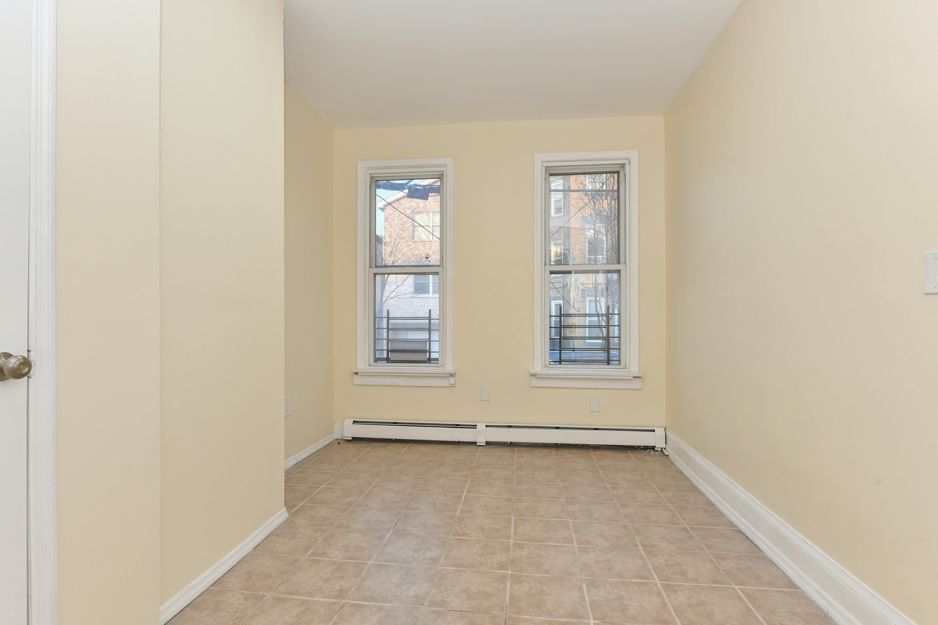 531 28th Street, Unit 1 Union City, NJ 07087 - Photo 8 of 21 an empty room with windows