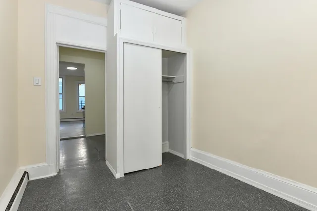 a view of an empty room and bathroom