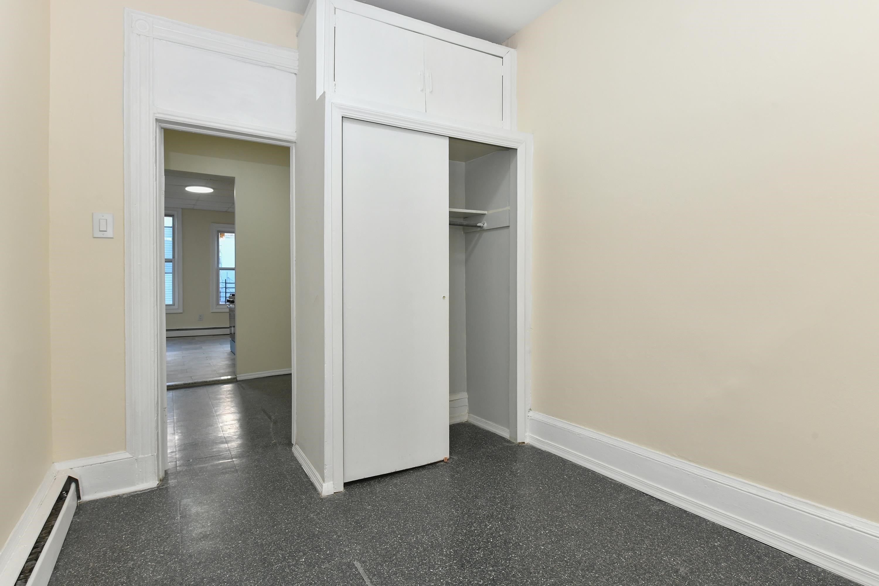 531 28th Street, Unit 1 Union City, NJ 07087 - Photo 9 of 21 an empty room with wooden floor and windows