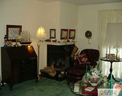 301 Raintree Court Helmetta, NJ 08828 - Photo 3 of 8 a living room with furniture and a fireplace