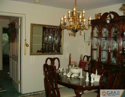301 Raintree Court Helmetta, NJ 08828 - Photo 4 of 8 a view of a dining room with furniture and chandelier