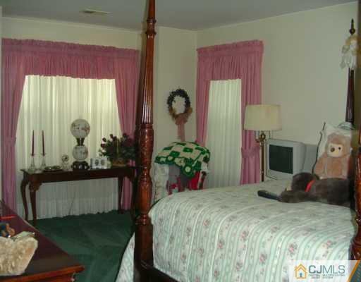 301 Raintree Court Helmetta, NJ 08828 - Photo 5 of 8 a bedroom with a bed and a window
