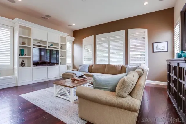a living room with furniture wooden floor and a flat screen tv