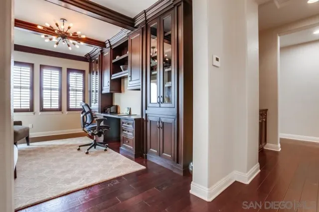 a view of a livingroom with workspace and a window