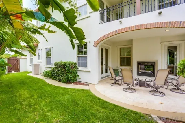 a view of a house with backyard porch and sitting area