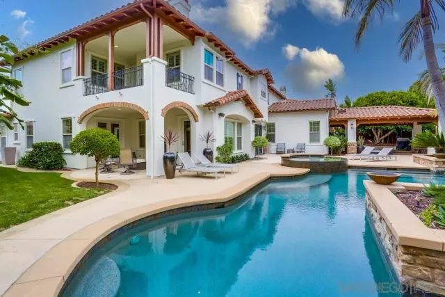 a swimming pool view with a seating space and a garden