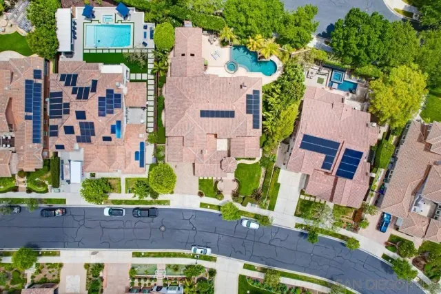 an aerial view of multiple houses with yard