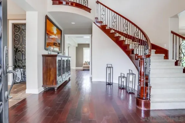 a view of entryway with wooden floor and stairs