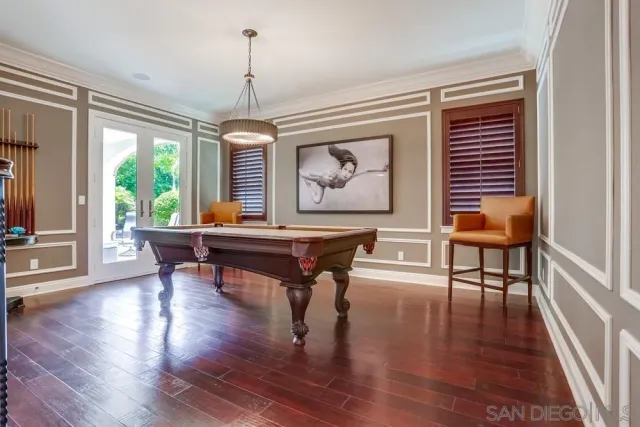 a workspace with table chairs and wooden floor