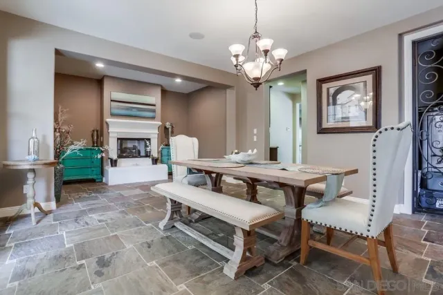 a living room with furniture a table and a chandelier