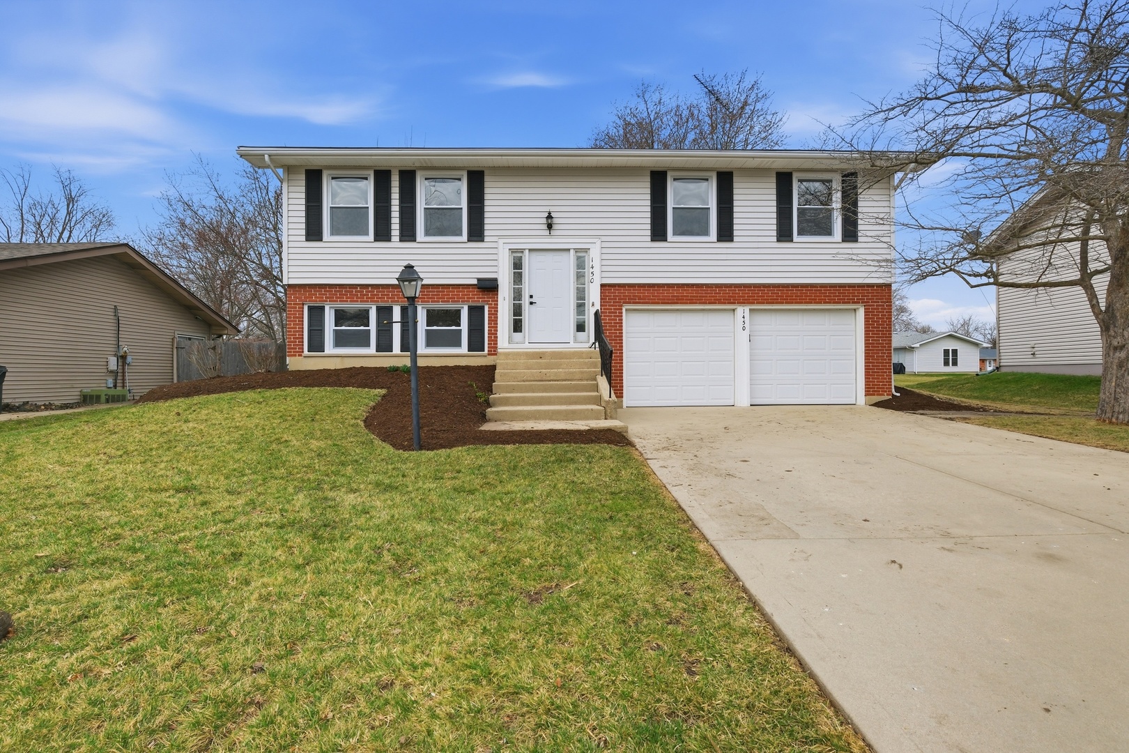 a front view of a house with a yard and garage