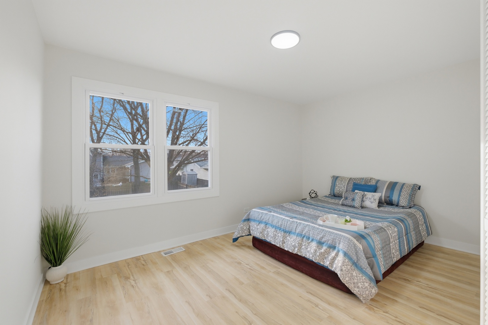 1450 Meyer Road Hoffman Estates, IL 60169 - Photo 10 of 28 a bedroom with a bed and a large window