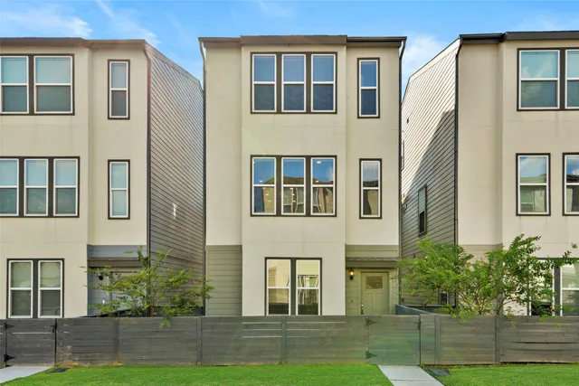 a front view of residential houses with yard