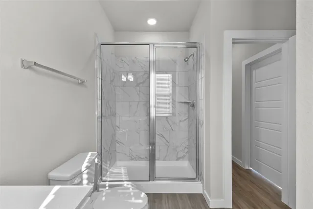 a bathroom with a glass shower door