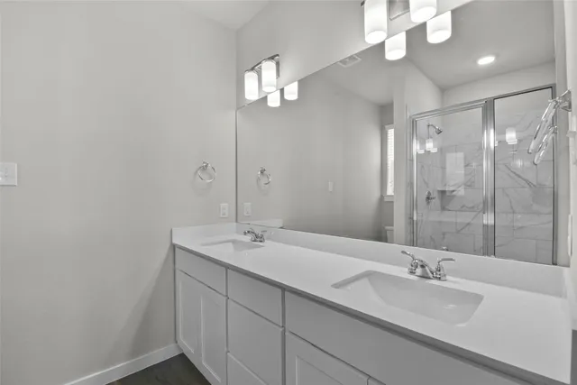 a bathroom with a double vanity sink and a mirror