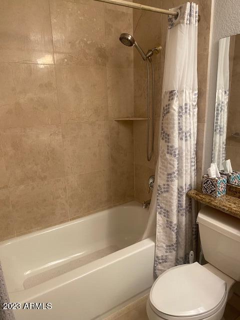 9707 East Mountain View Road, Unit 1414 Scottsdale, AZ 85258 - Photo 15 of 40 a white toilet and tub sitting next to a bathroom sink