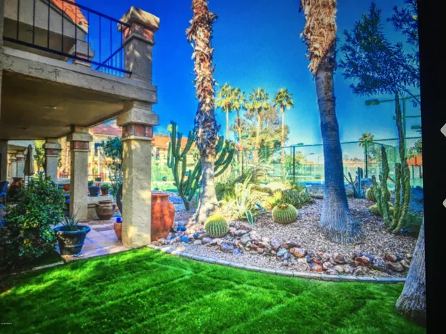 a view of a house with a backyard and a patio