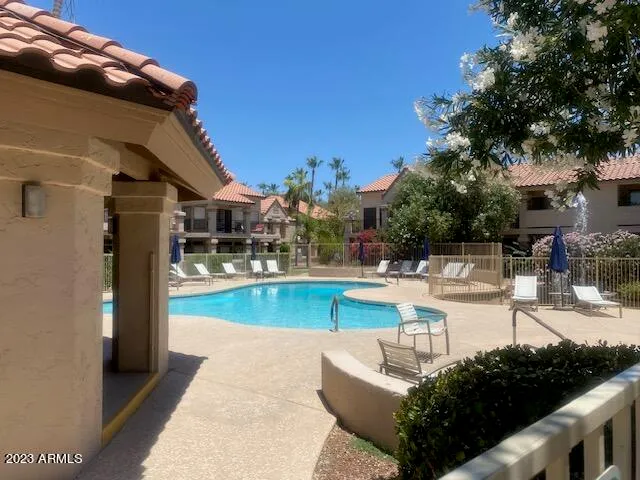 a swimming pool with outdoor seating and yard