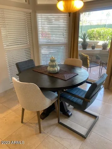 a view of a dining room with furniture and window