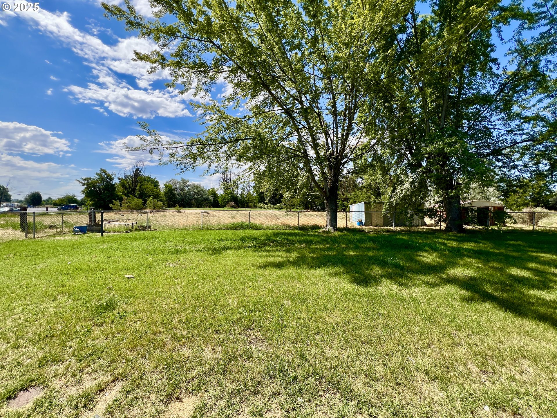 32540 East Punkin Center Road Hermiston, OR 97838 - Photo 15 of 19 a view of grassy field with benches