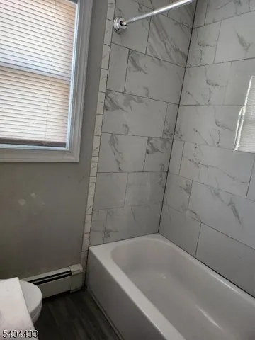a bathroom with a bathtub and toilet