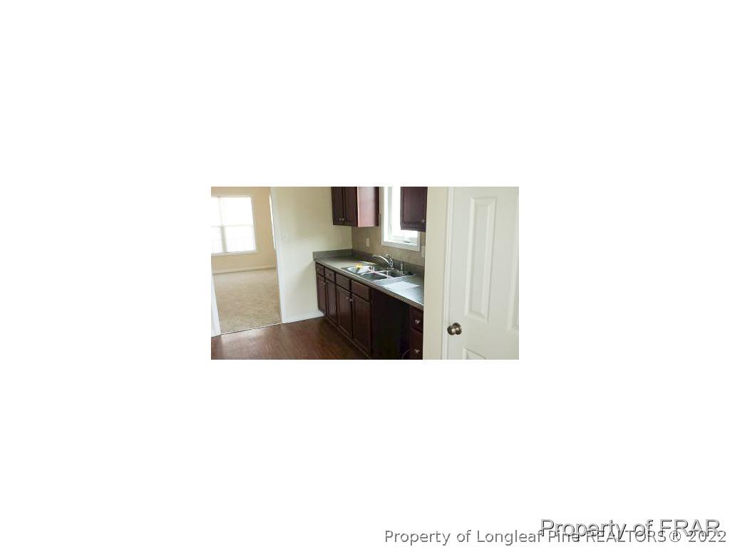 712 Cape Fear Road Raeford, NC 28376 - Photo 4 of 12 a kitchen with sink and cabinets