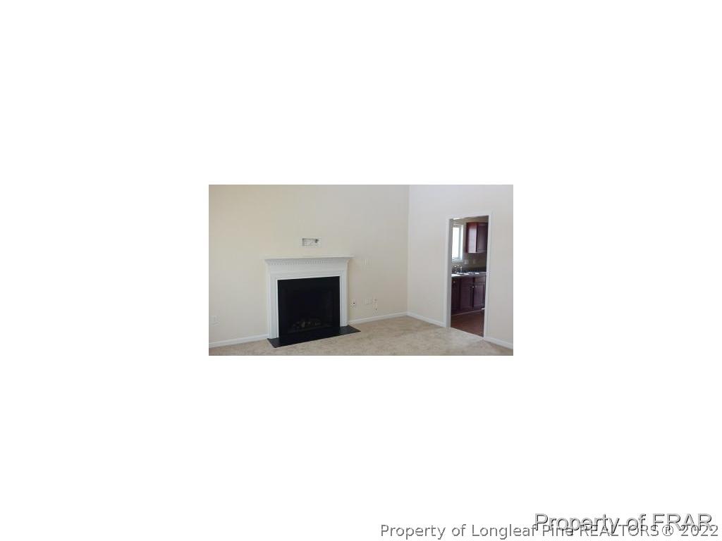 712 Cape Fear Road Raeford, NC 28376 - Photo 6 of 12 a living room with a couch and a fireplace