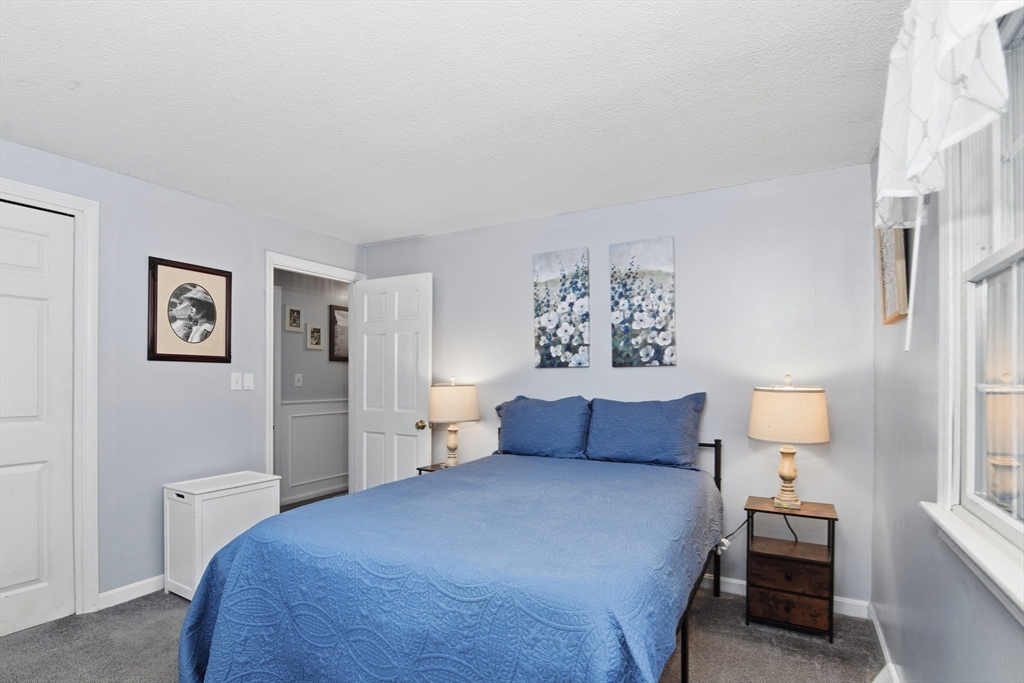 80 Walnut Street Middleboro, MA 02346 - Photo 17 of 34 a bedroom with a bed and a lamp on dresser