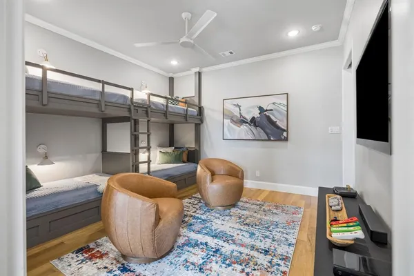 a bedroom with a bed and a wooden floor