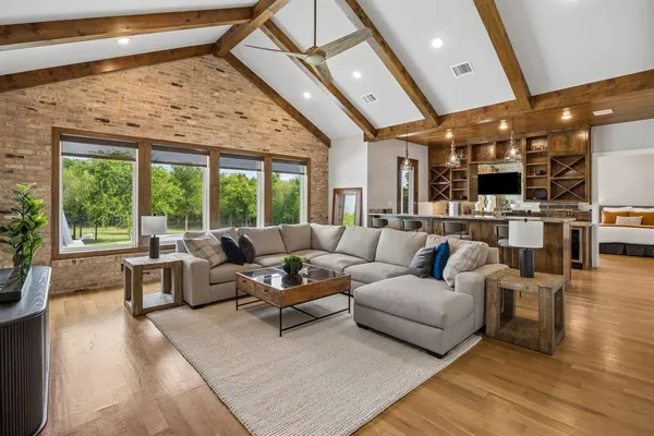 a kitchen with stainless steel appliances granite countertop lots of counter top space and wooden floor