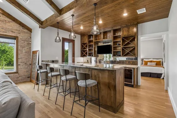 a bedroom with furniture and a large window