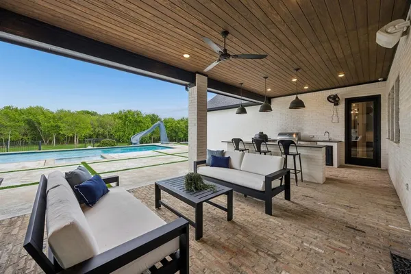 a kitchen with kitchen island stainless steel appliances a sink and stove
