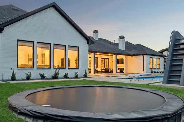 an aerial view of a house with swimming pool garden and patio